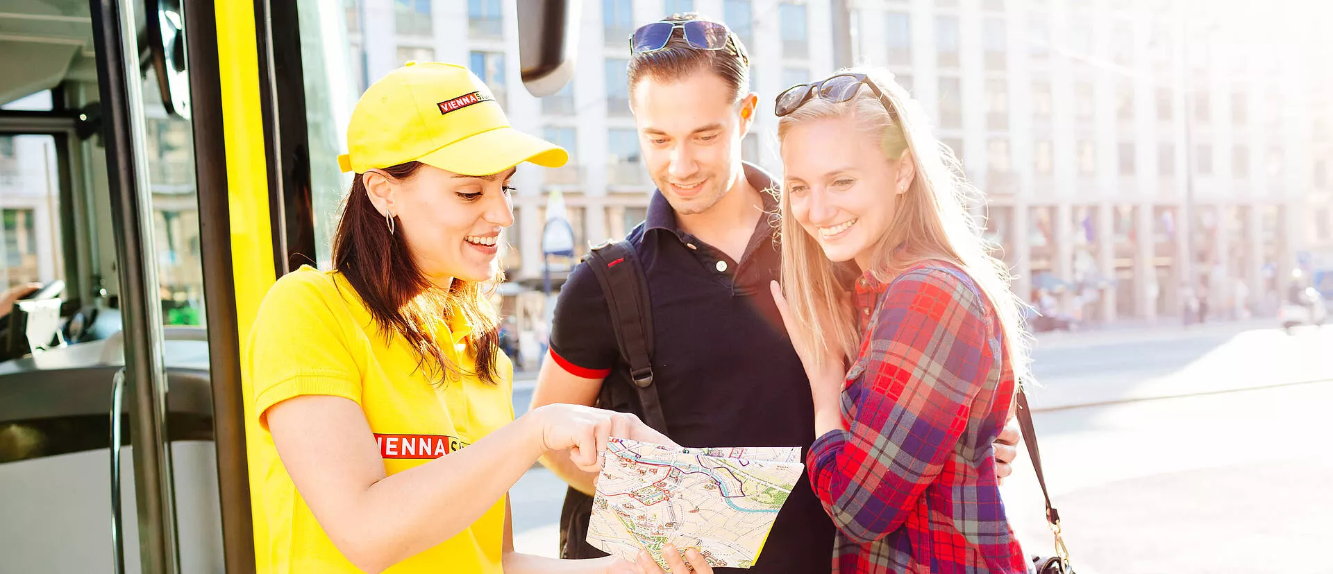 Vienna Sightseeing Tours Un couple de touristes recevant des conseils d’une employée de Vienna Sightseeing Tours.